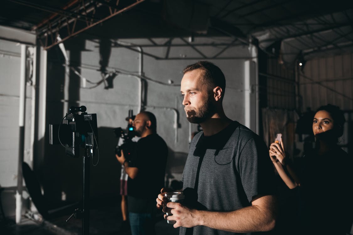 Person with film crew shooting a documentary