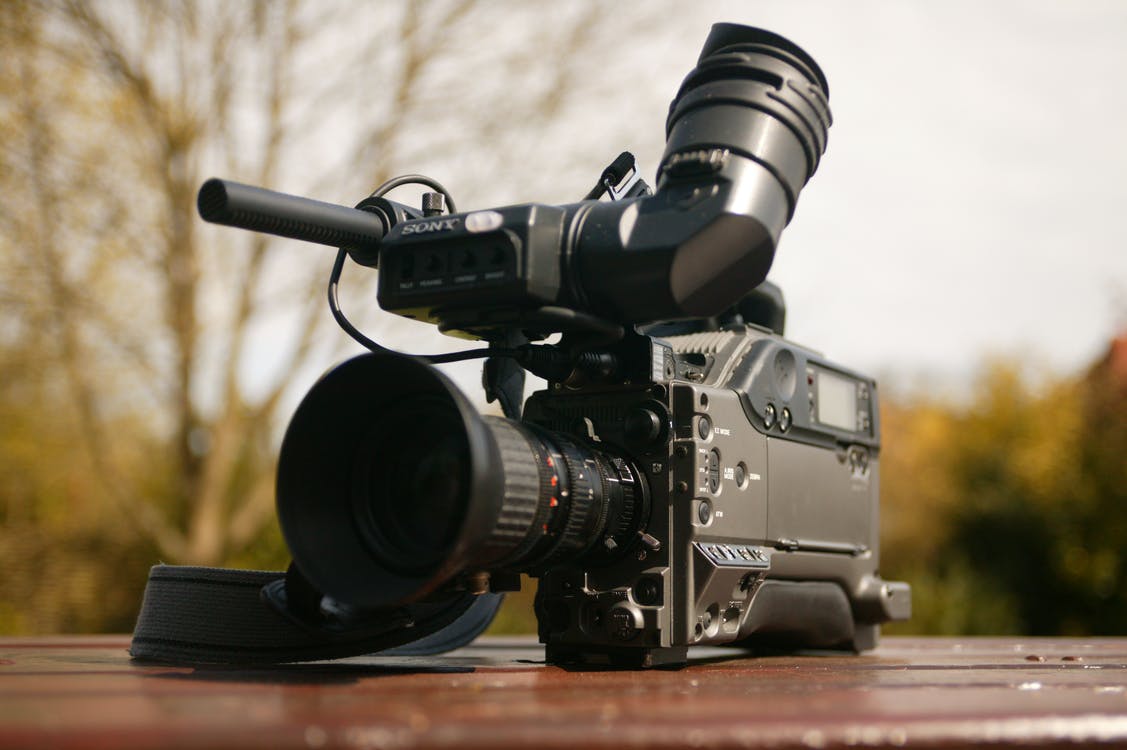 Sony pxw-fs7 video camera with microphone on a table in the nature