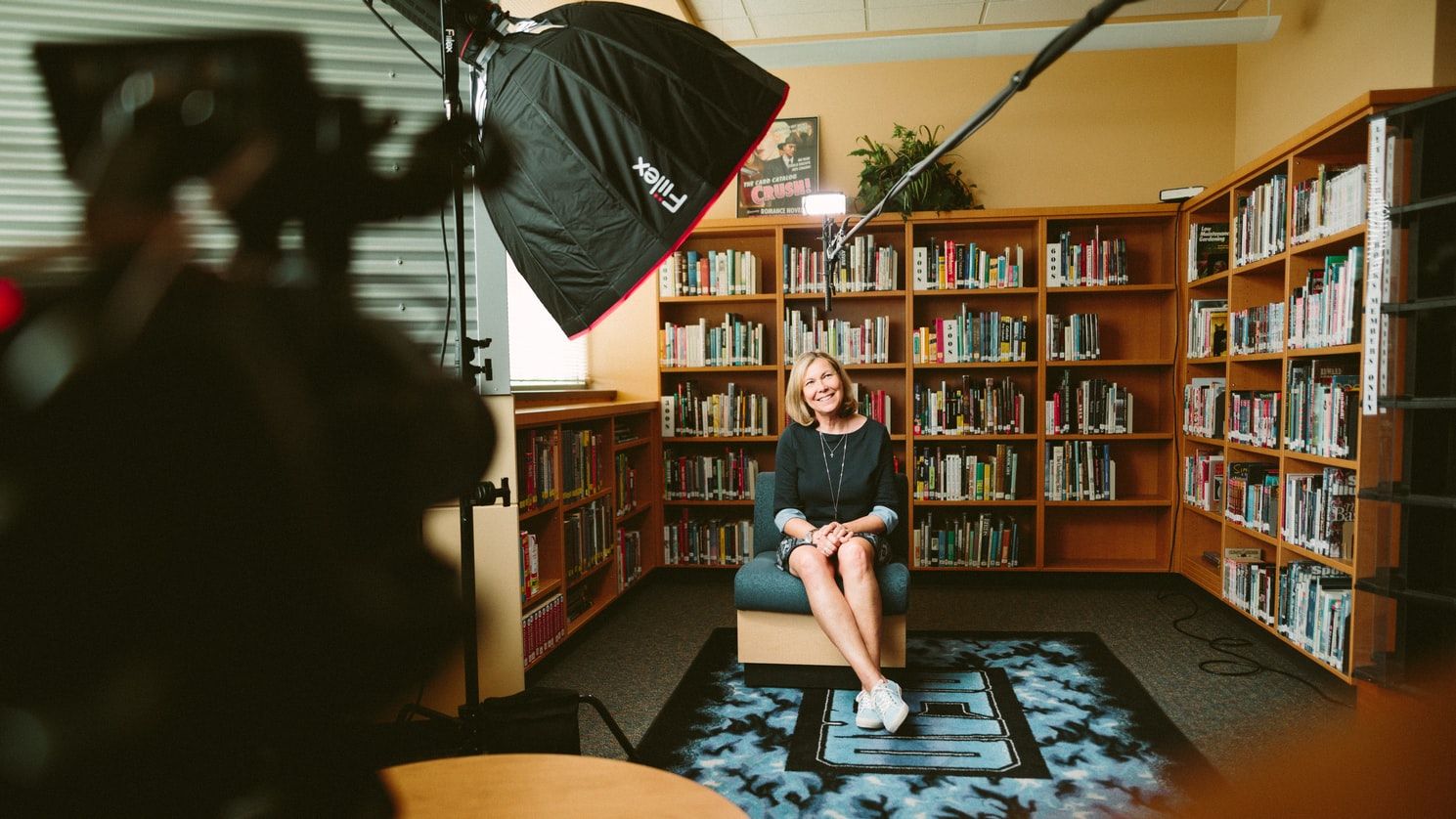 documentary filmmaking woman sitting in the library being interviewed