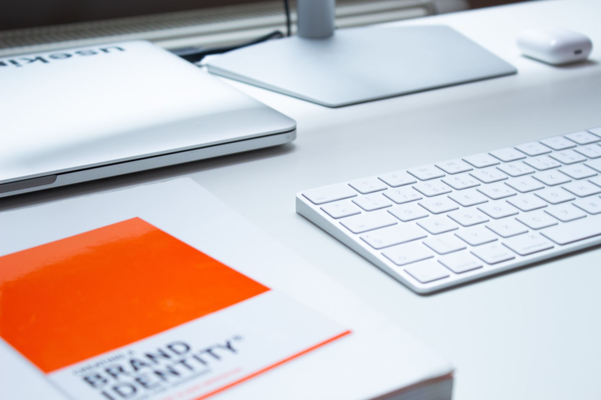 book-on-brand-identity-with-macbook-on-table