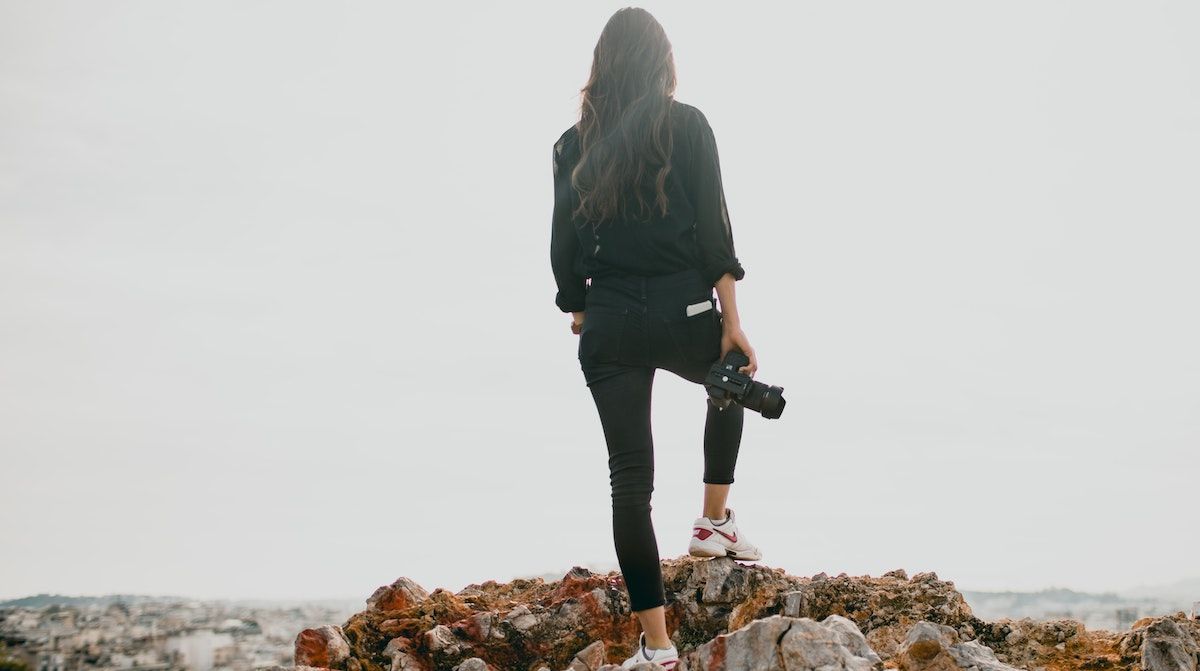 photographer standing on a cliff