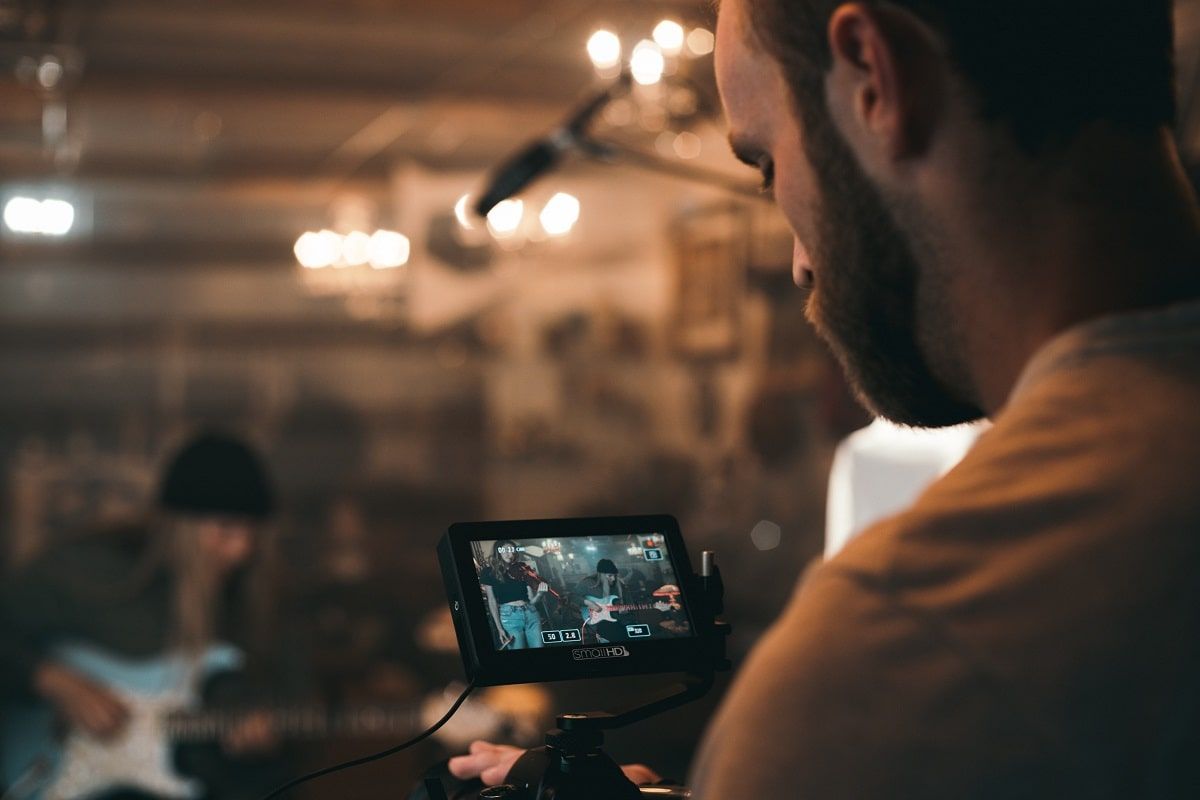 camera man filming guitar player