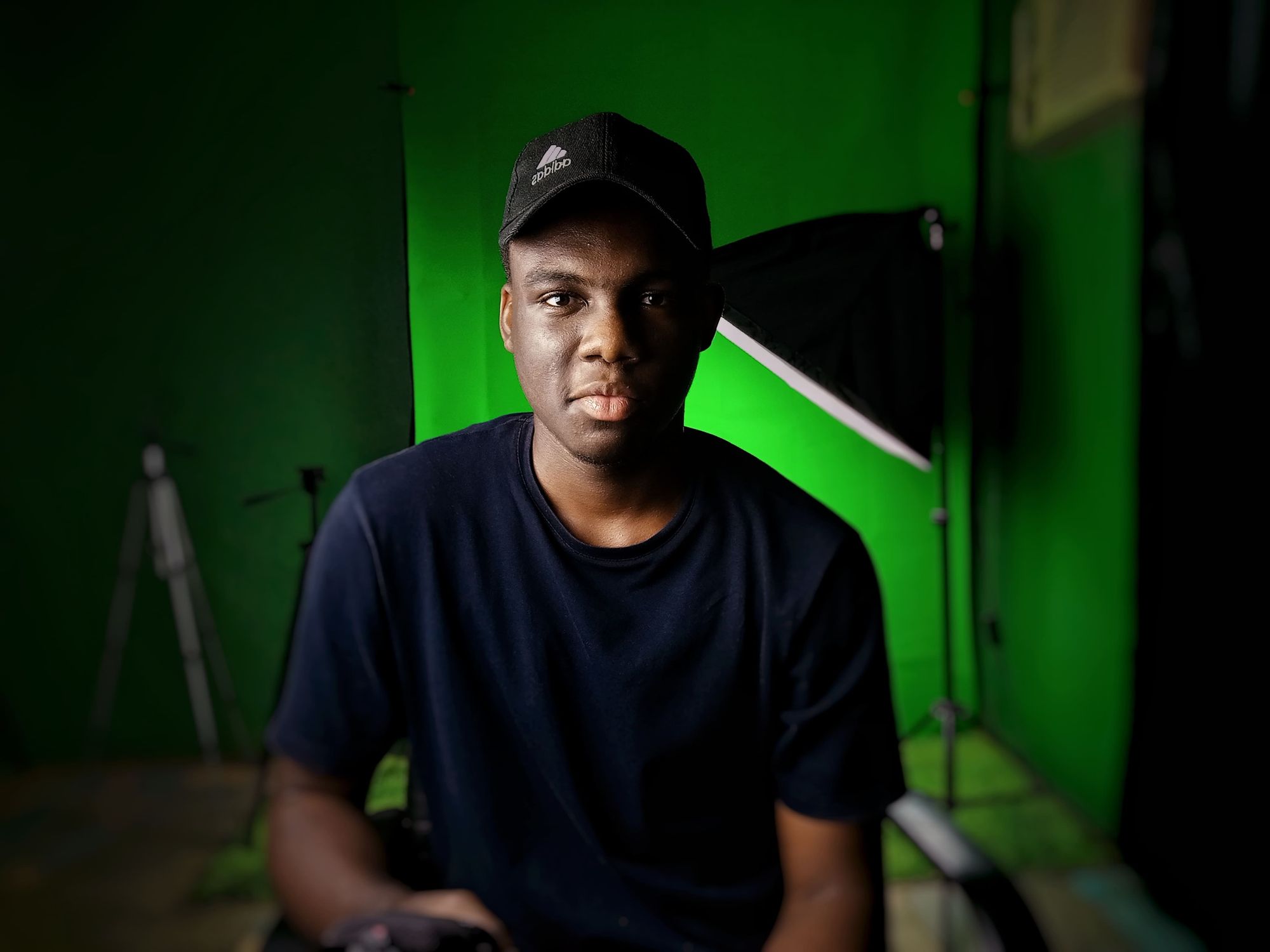 A man sitting in front of a green screen