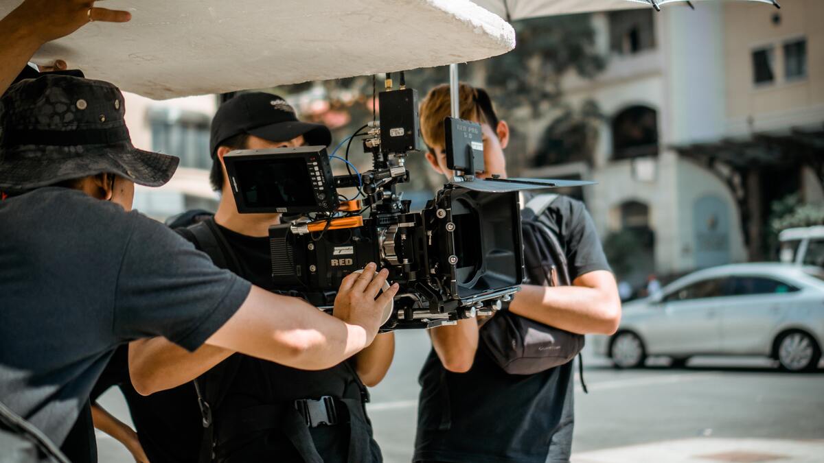 several filmmakers handling a camera