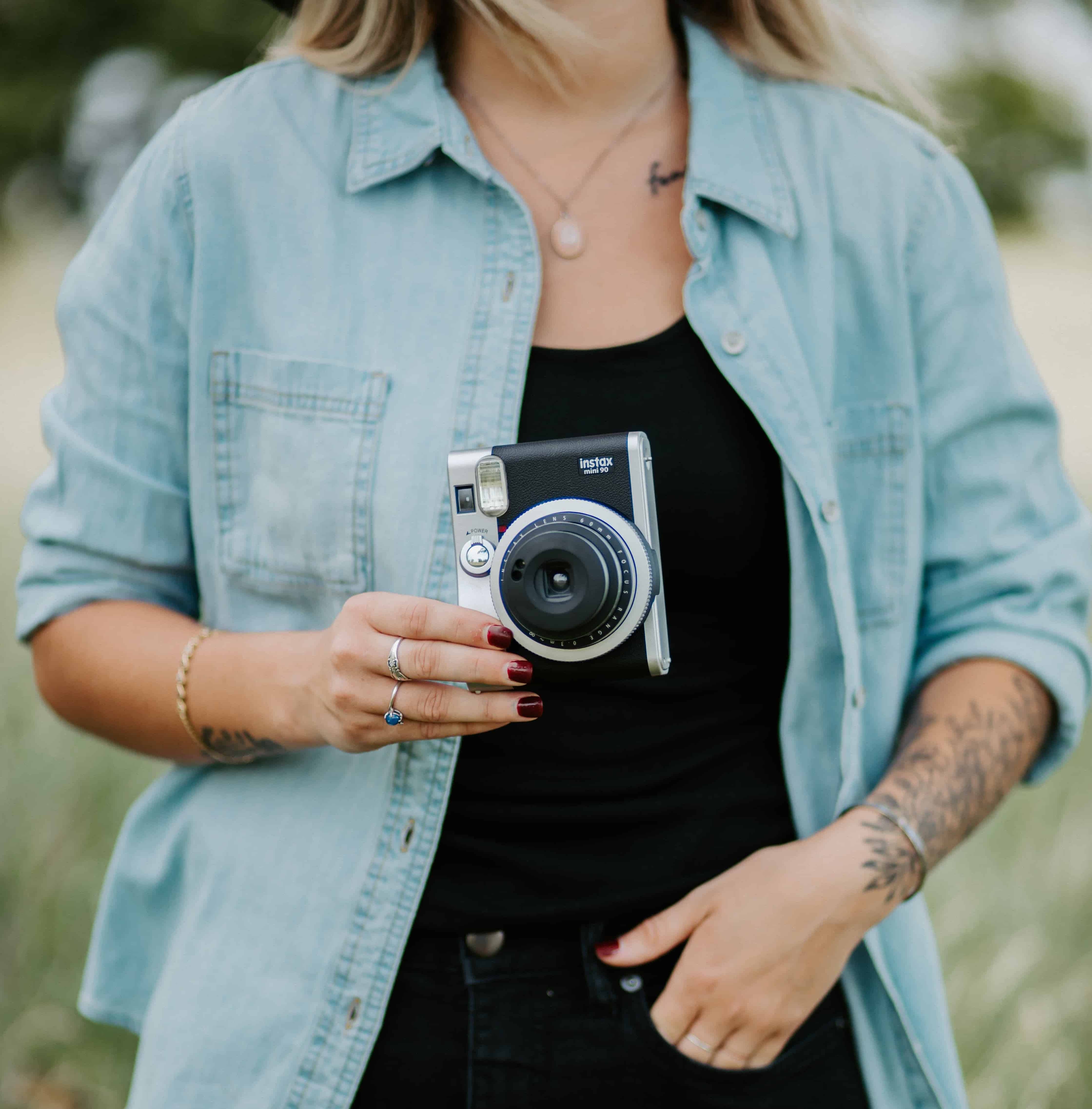 woman holding mirrorless camera