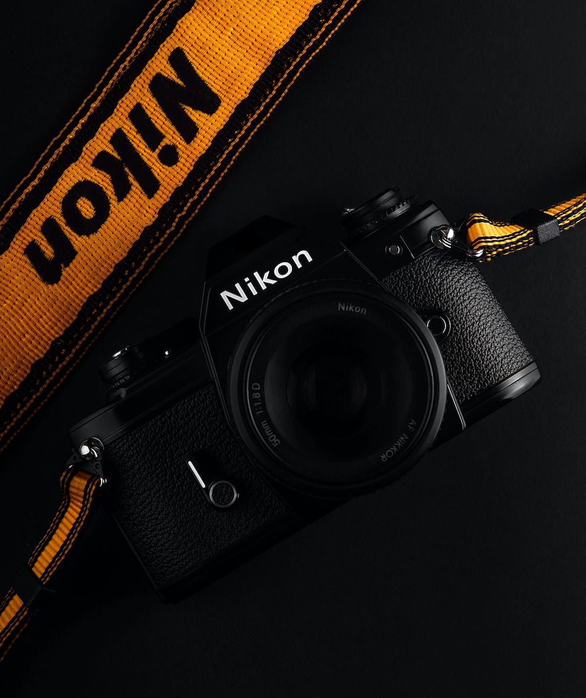 Nikon body. Оранжевая видеокамера на черном. Nikon Black Инстаграм. Черно черно оранжевая камера. Nikon Black песни.